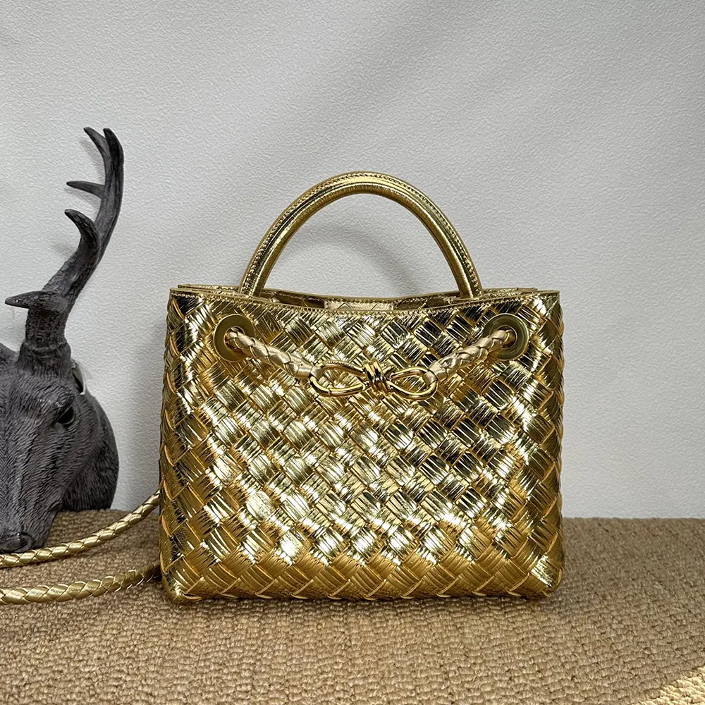 Close-up of intrecciato leather texture and gold clasp on Andiamo Handle Bag