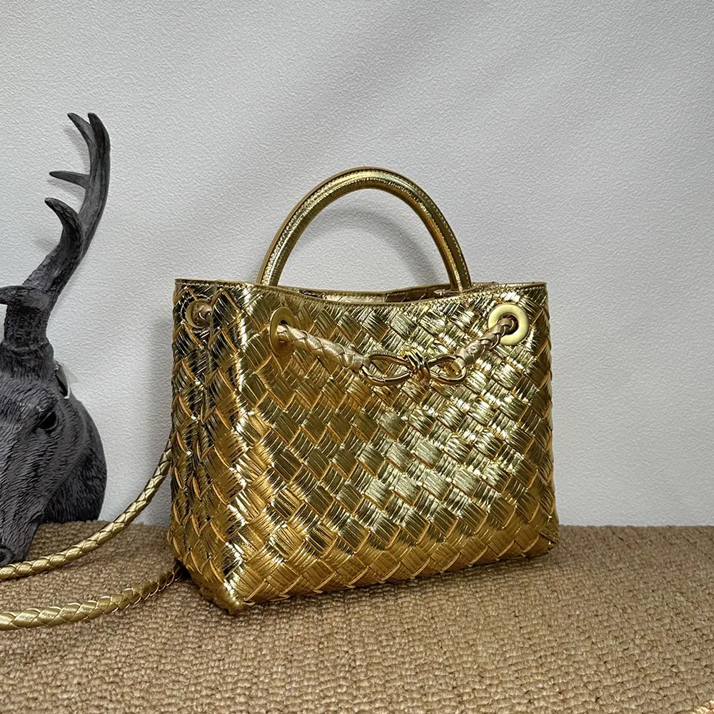 Side angle showing structured silhouette and top handle of Small Andiamo Handle Bag