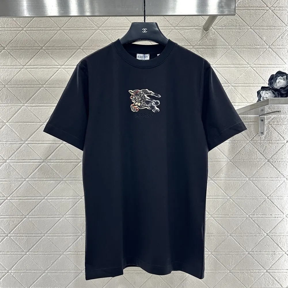 Close-up detail of Burberry EKD check on black cotton T-shirt fabric