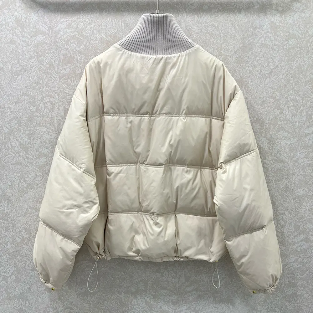 Side angle showing relaxed silhouette of Celine Women Puffer Jacket In Light Nylon-Beige