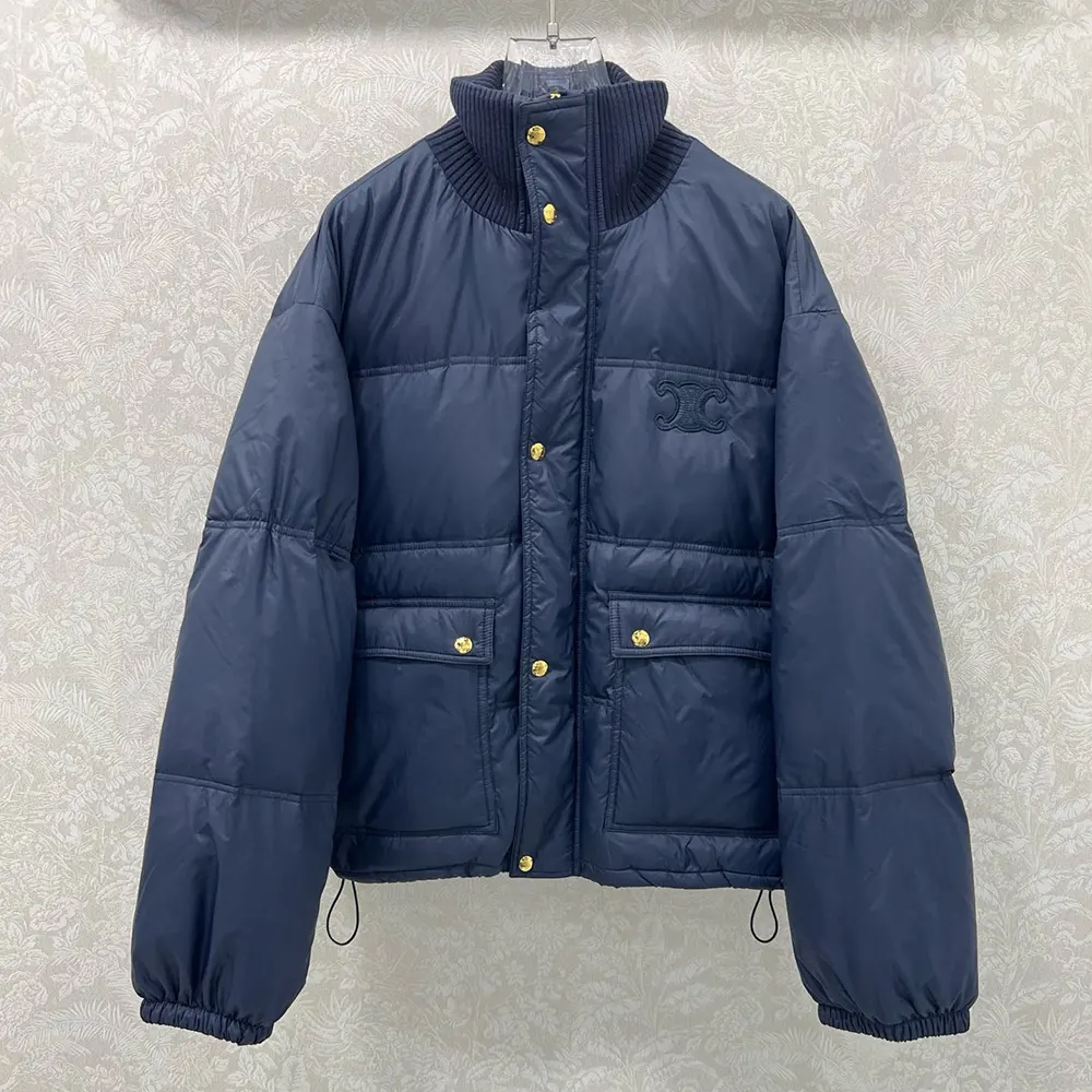 Close-up of zip and Celine logo hardware on navy puffer jacket