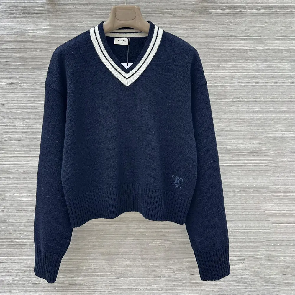 Close-up detail of Celine logo on navy cashmere sweater neckline