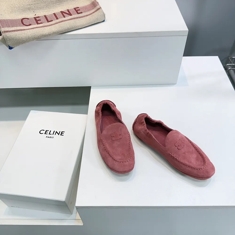 Close-up detail of pink suede and gold hardware on Celine loafers