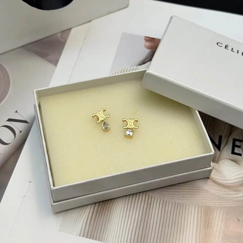 Side angle showing gold brass and post closure of Celine Women Triomphe Twinkle Earrings