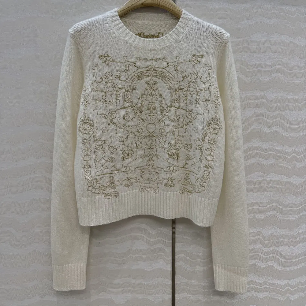 Close-up of gold-tone Dioresque Stella motif embroidery on Dior sweater