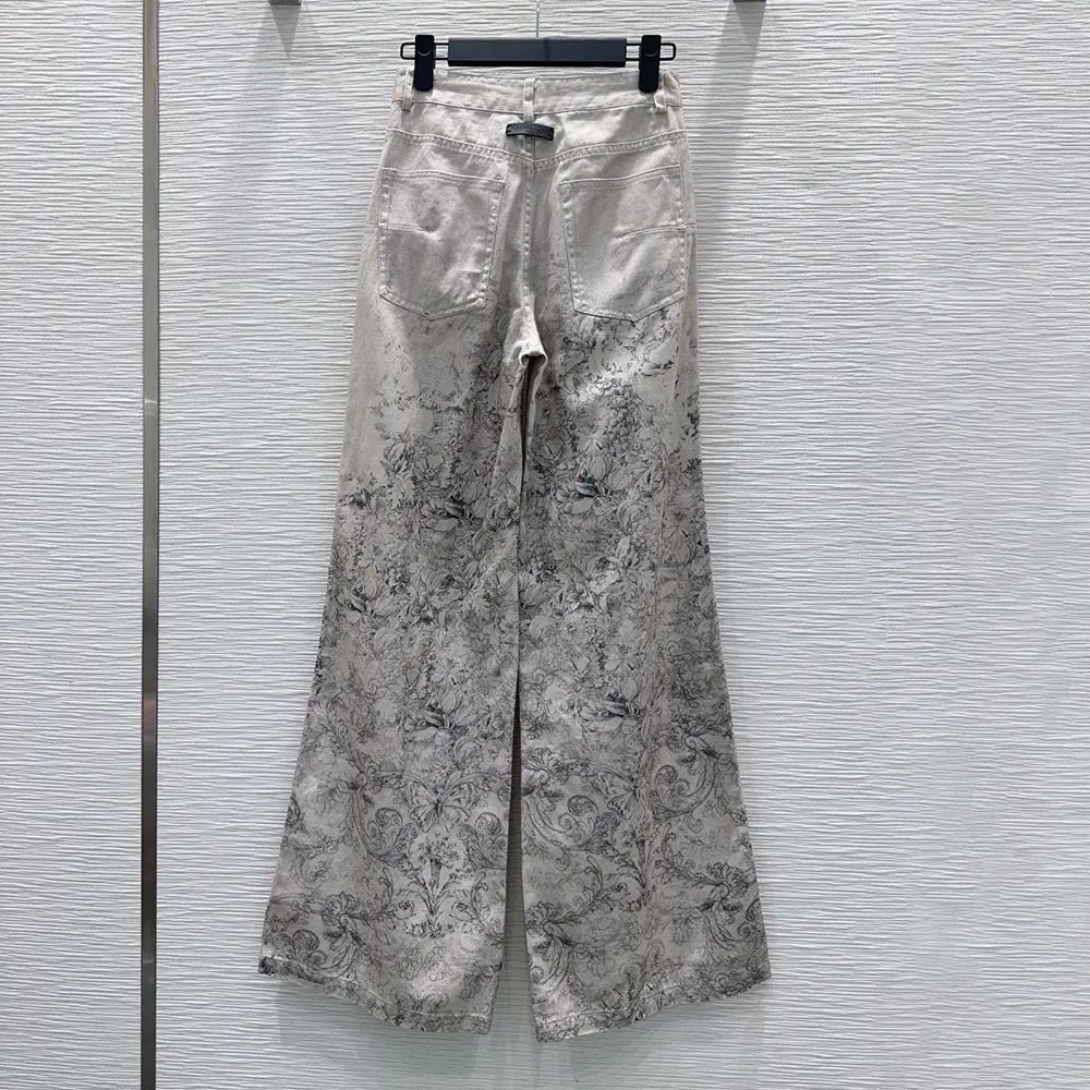 Close-up of Dior Barocco pattern detail on beige flared jeans