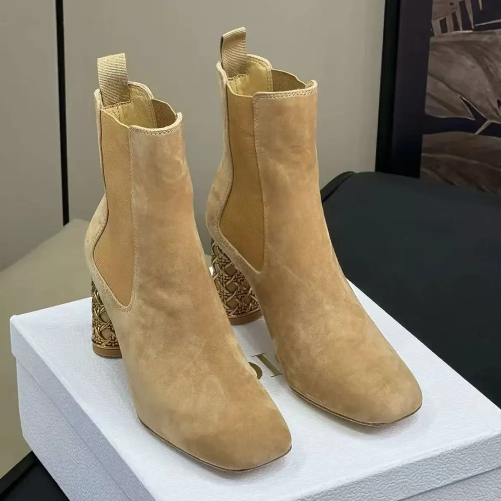 Close-up on Dior metal hardware detail on brown suede boot
