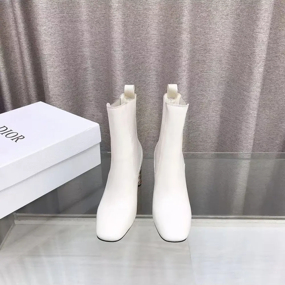 Close-up of white calfskin and Dior metal detail on boot