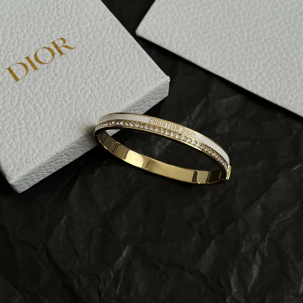 Wrist shot featuring Dior Women Night Code Bangle shining under light