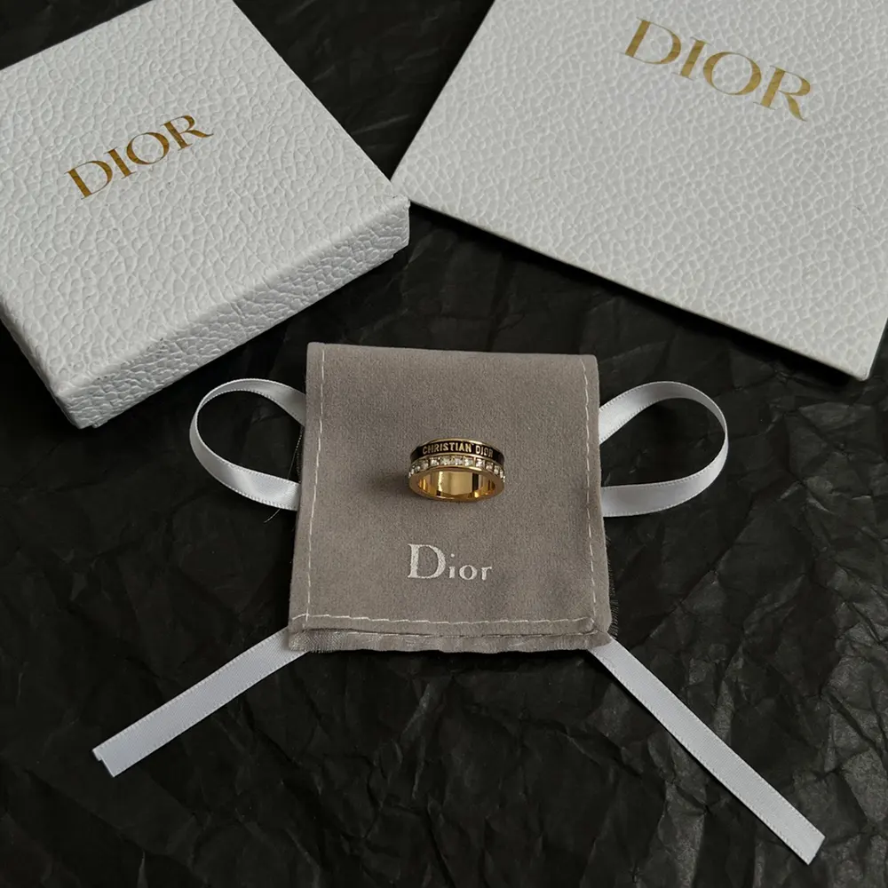 Side profile showcasing black lacquer and adjustable band of Dior Women Night Code Ring