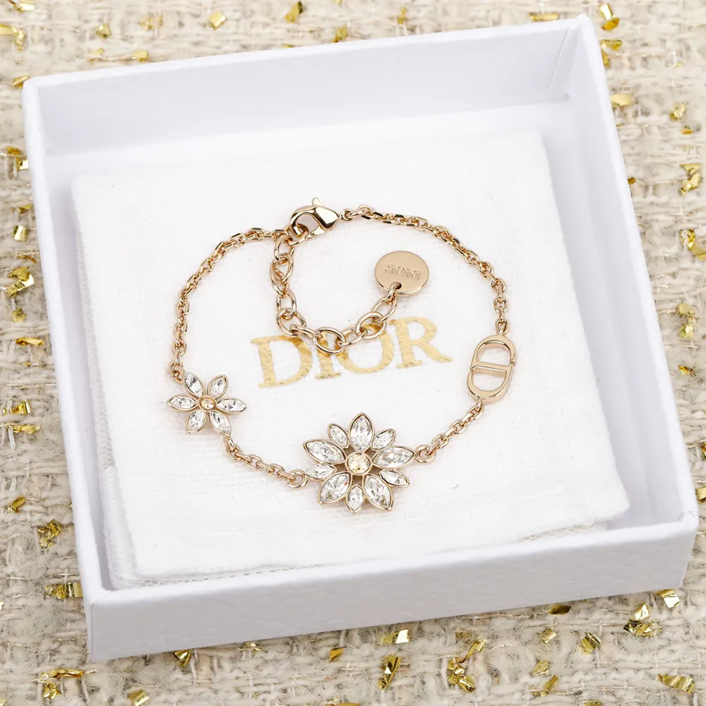 Side angle showing petite silhouette of Dior Women Petit CD Lucky Baroque Earrings