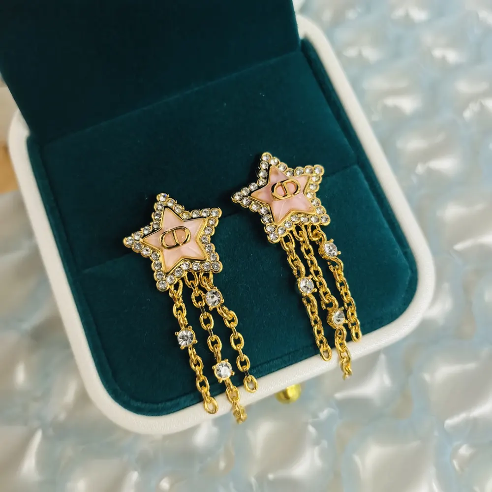 Side angle showcasing pink hue and butterfly closure of Dior Women Petit CD Lucky Baroque Earrings