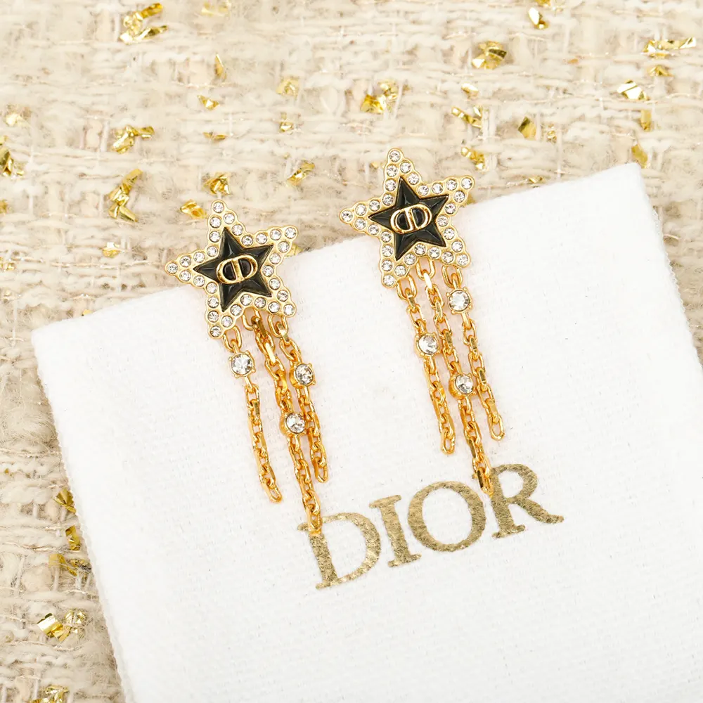 Close-up detail of gold-finish metal and silver-tone crystals on Dior earrings
