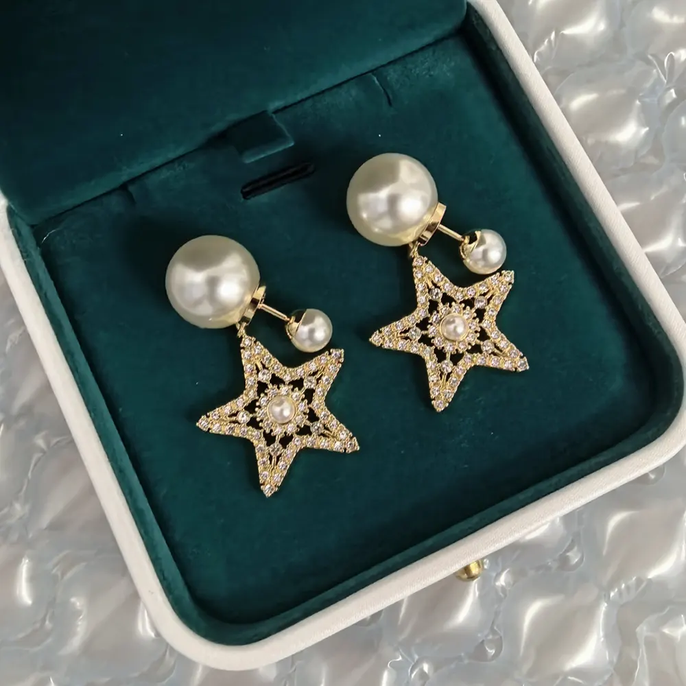 Detail of white resin pearls and silver-tone crystals on Dior earrings