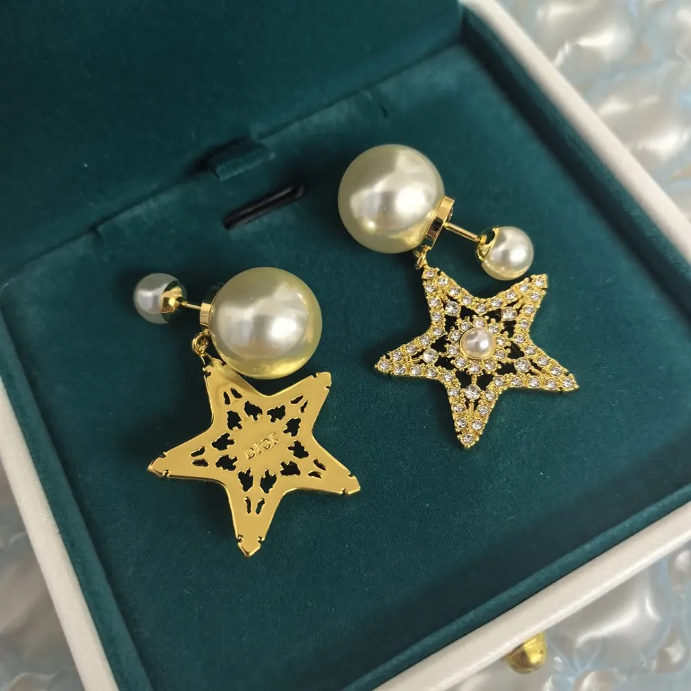 Side view showing pale gold-finish metal of Dior Women Tribales Earrings