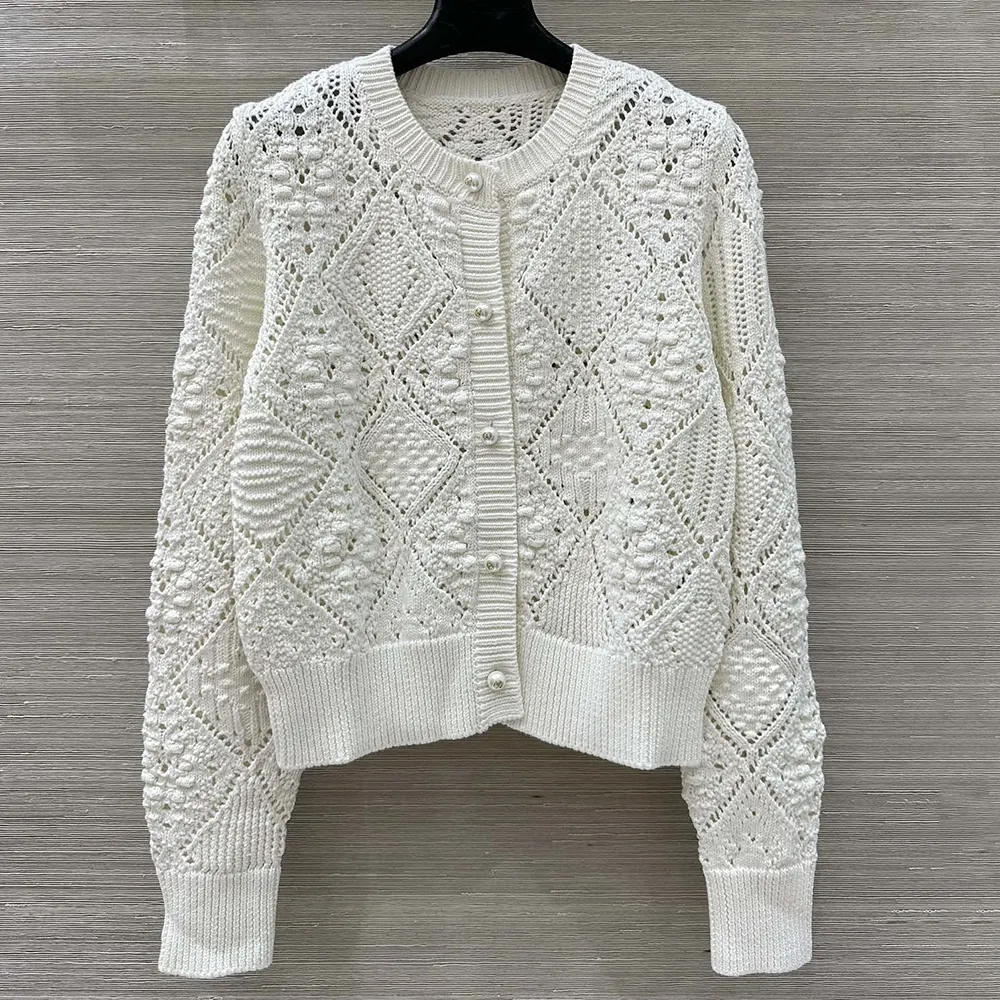 Close-up of Dior buttons on the white cotton knit twinset