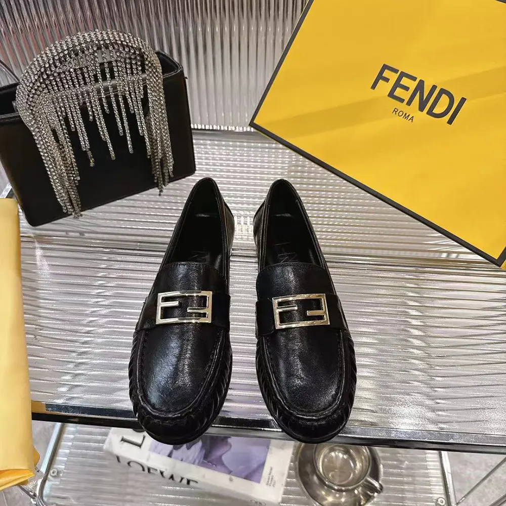 Close-up of black nappa leather and baguette detail on Fendi loafers