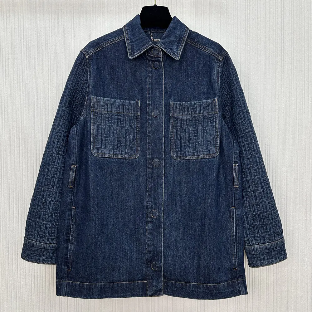 Close-up of signature Fendi metal buttons on dark blue denim jacket