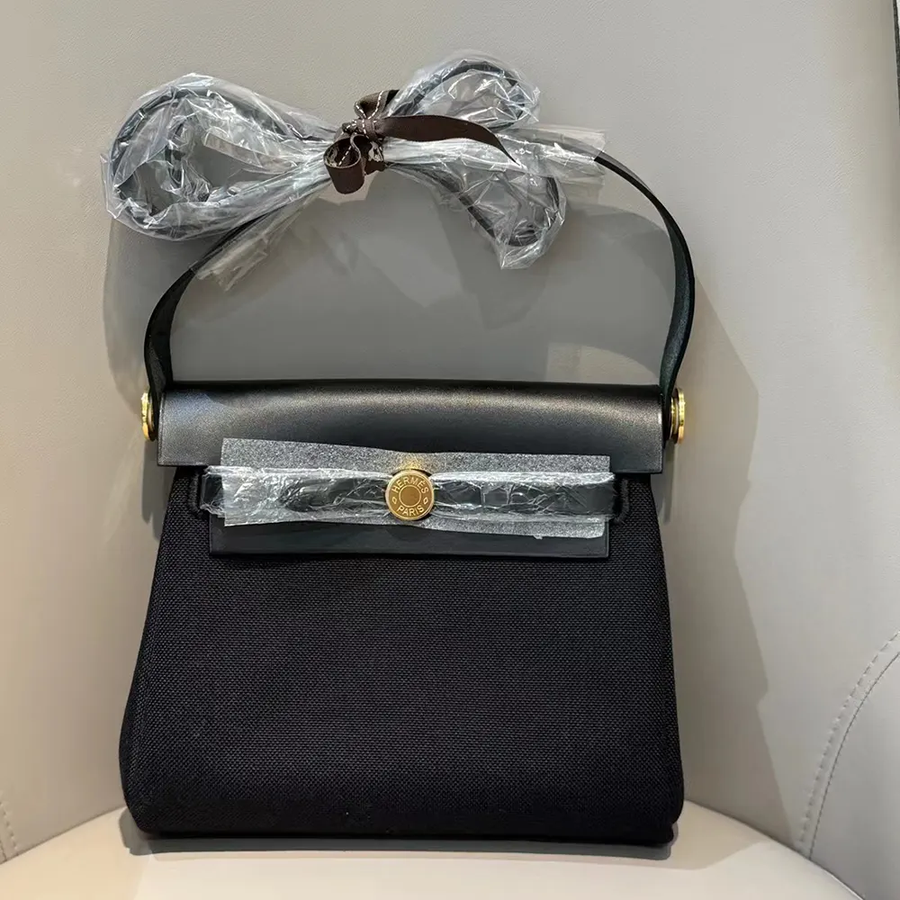 Close-up of gold hardware on Hermes Women Herbag Zip 20 Bag-Black/Gold