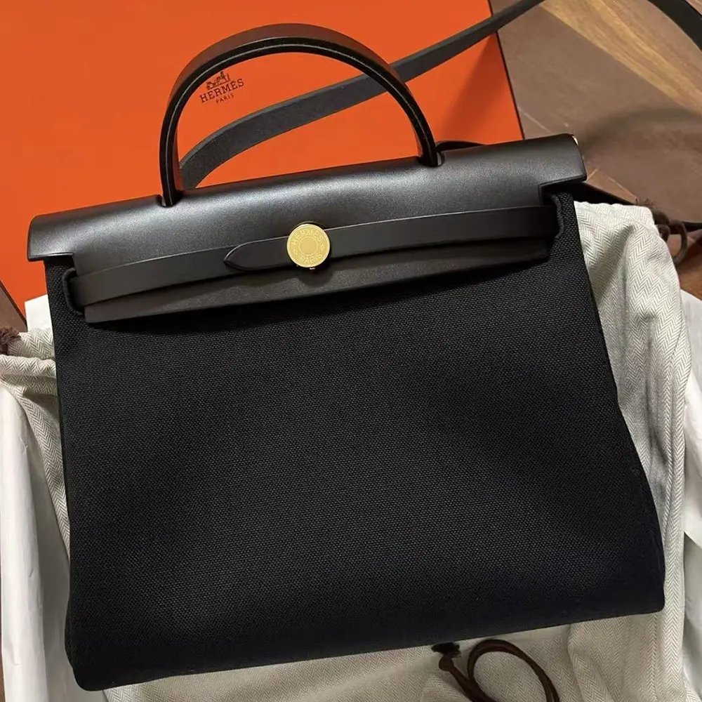 Side profile showing smooth black leather of Hermes Women Herbag Zip 31 Bag