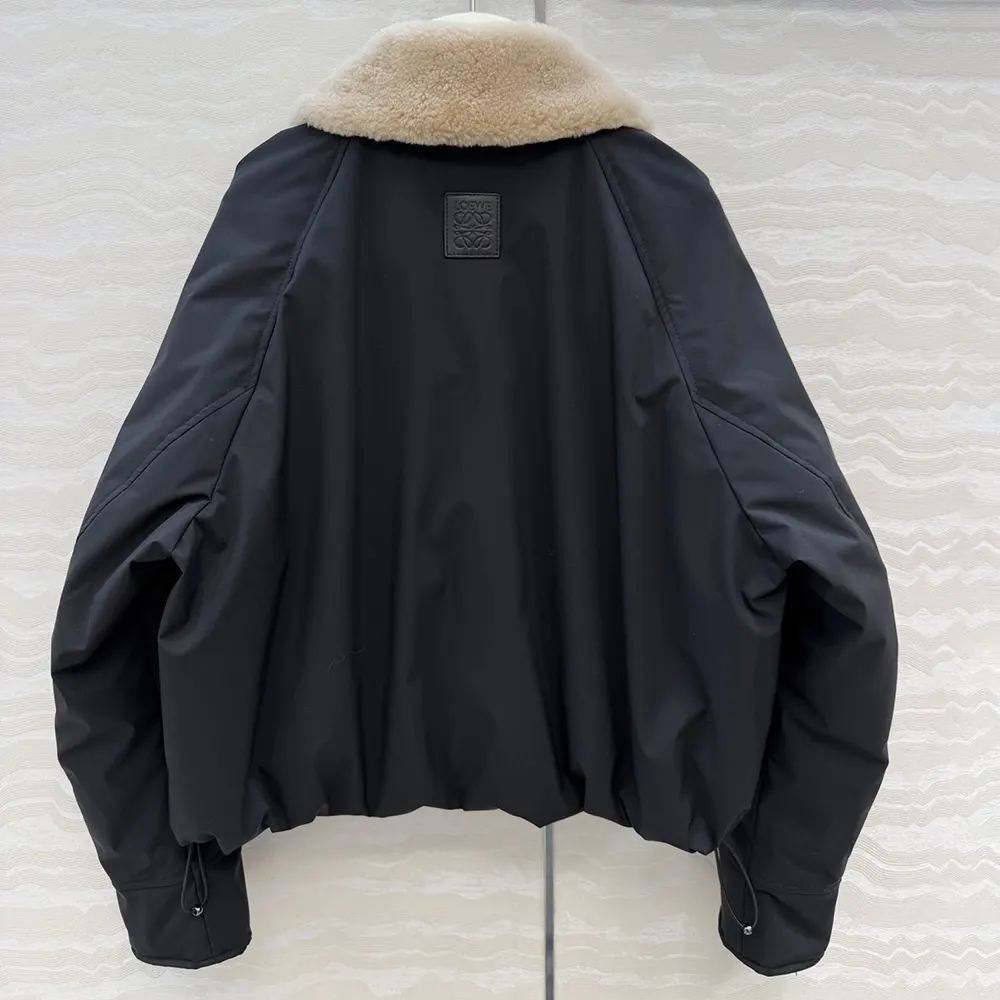 Side angle showing relaxed fit of Loewe Women Puffer black coat