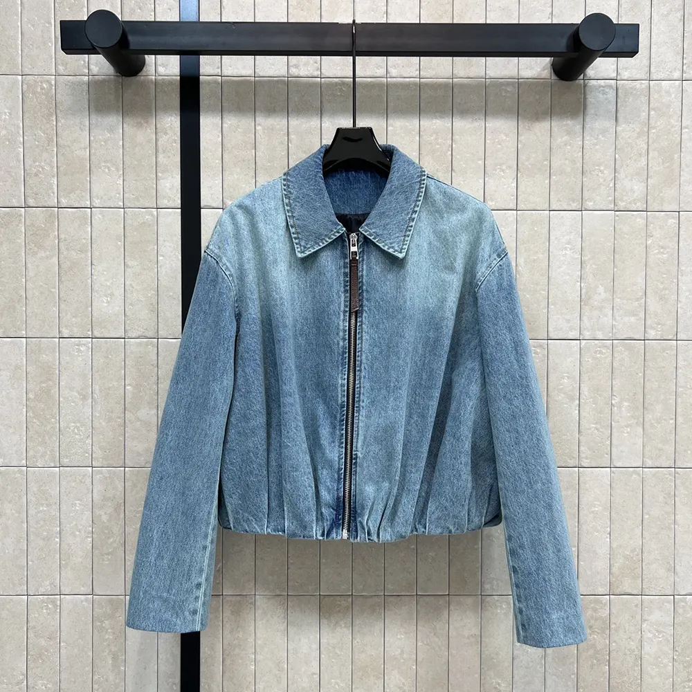 Close-up of Loewe embossed hardware on Denim-Indigo Blue draped jacket sleeve