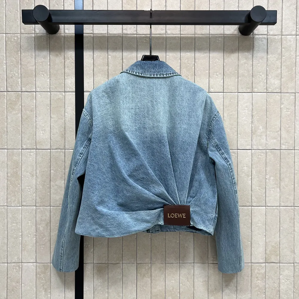 Side profile showing draped silhouette and texture of Loewe Denim-Indigo Blue jacket