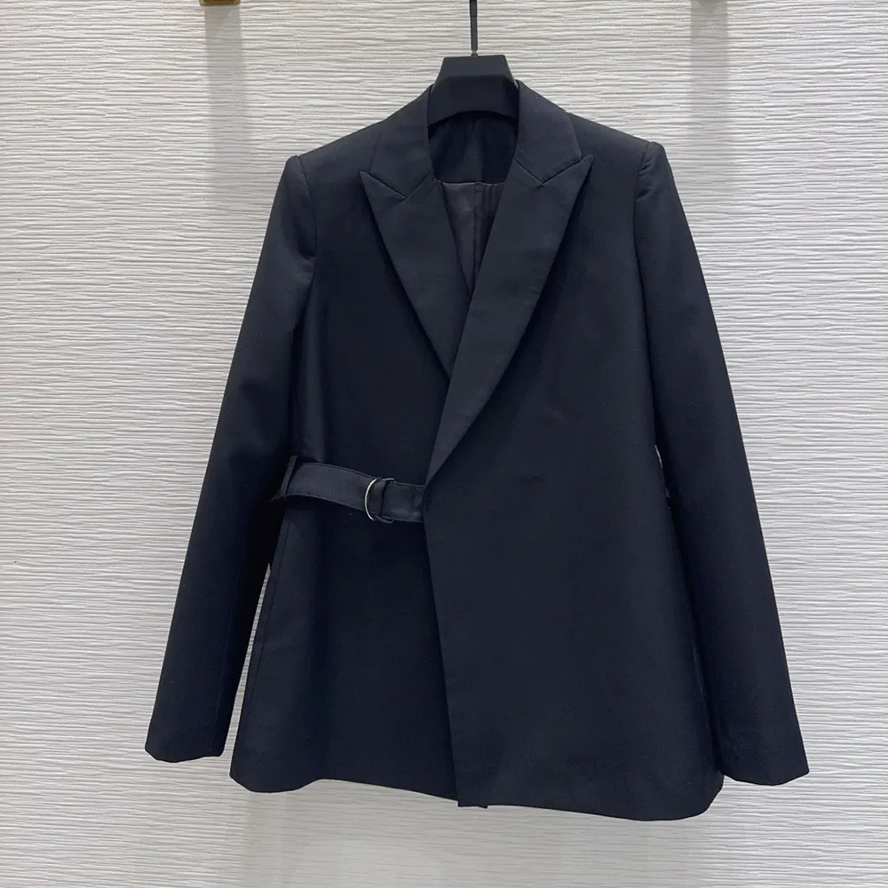 Close-up of black wool fabric and concealed button closure on Loewe jacket