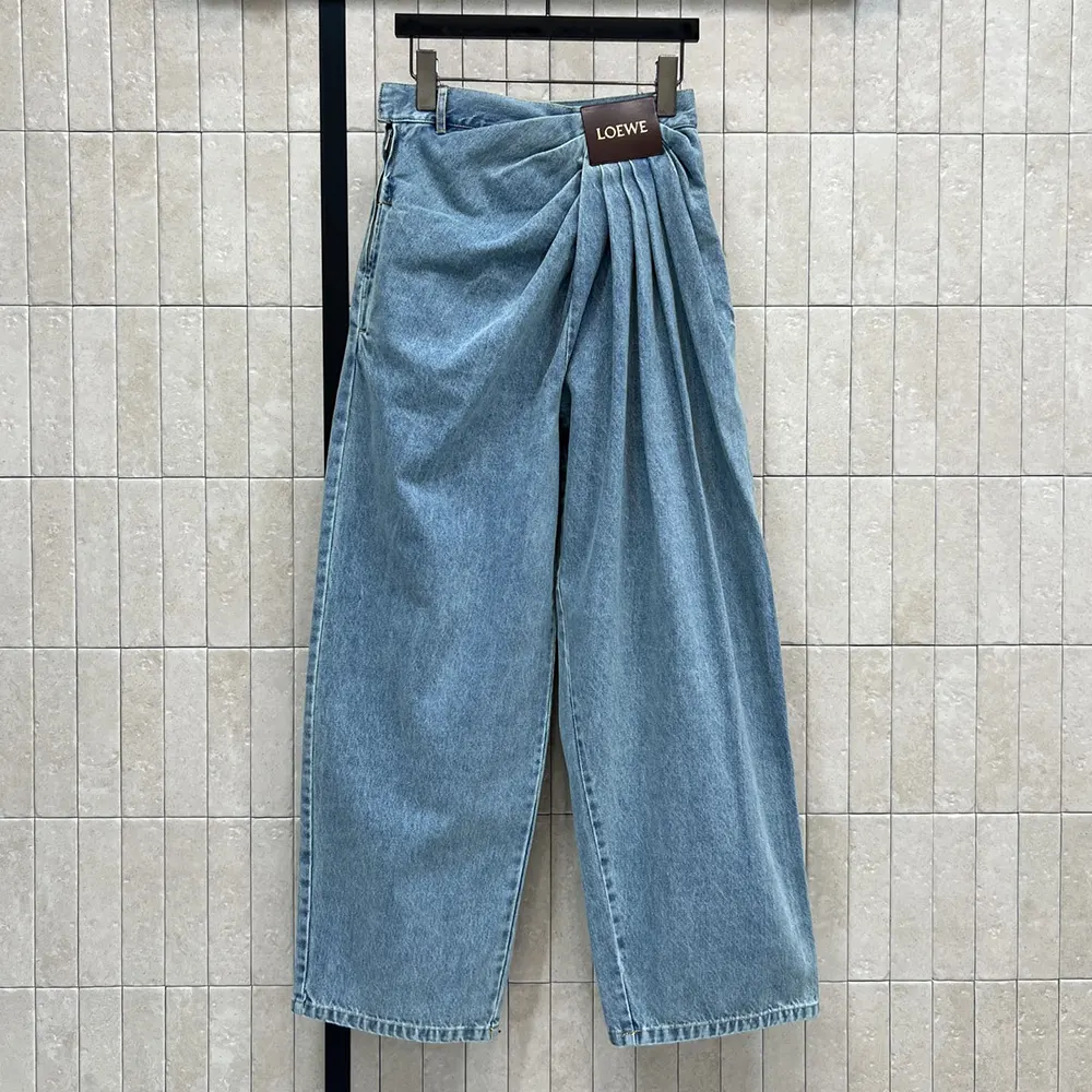 Close-up of signature Loewe stitching on denim-indigo jeans