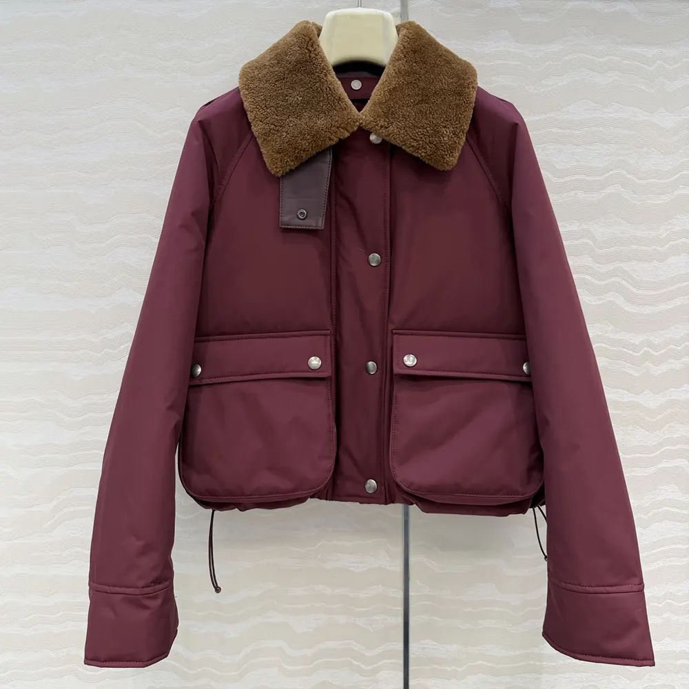 Close-up of shearling lining and embossed Loewe hardware on burgundy puffer
