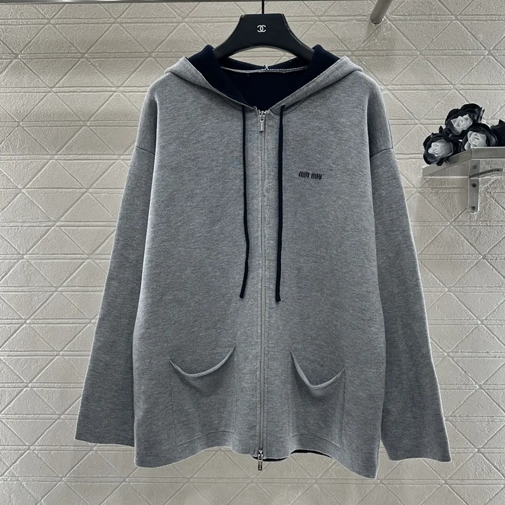 Close-up of zipper and cashmere knit on Miu Miu cardigan hoodie