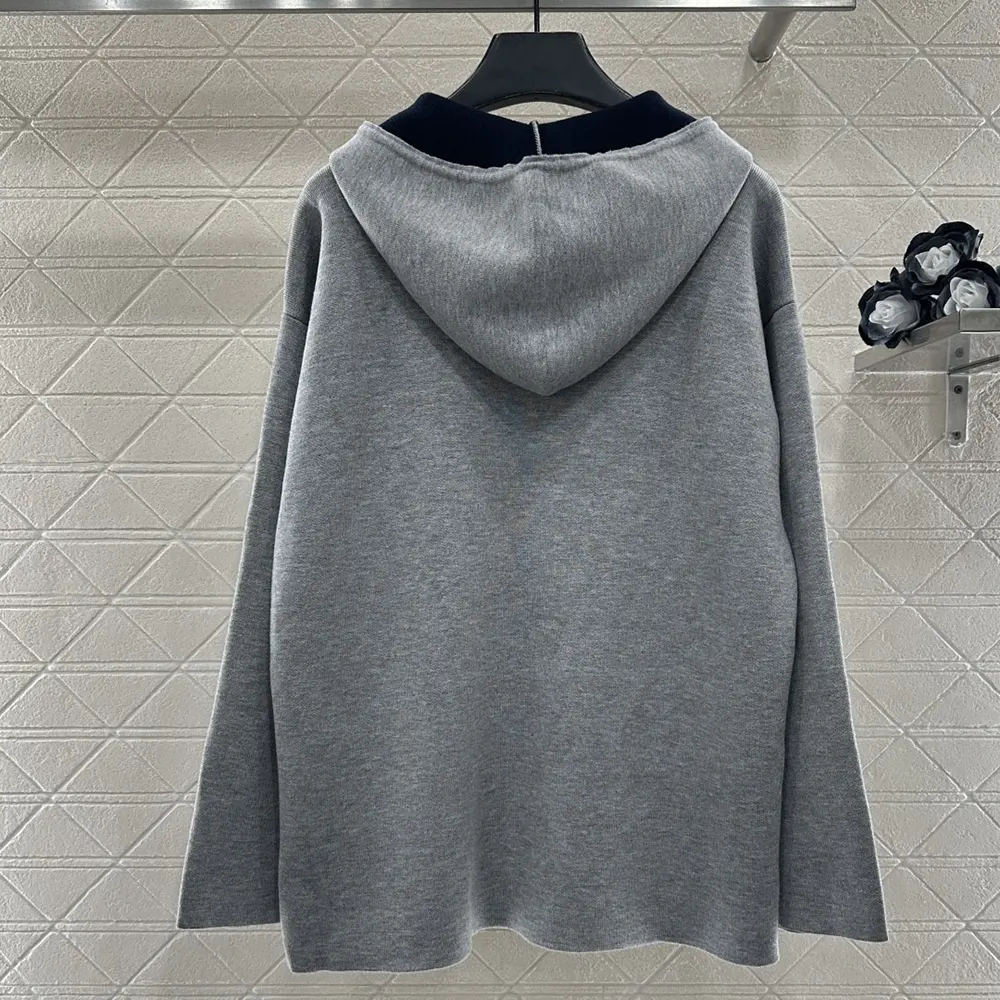 Side profile showcasing relaxed silhouette of Miu Miu cardigan hoodie