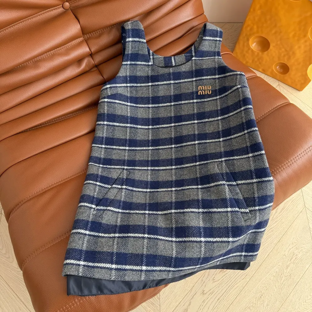 Close-up of navy check pattern and Miu Miu hardware detail