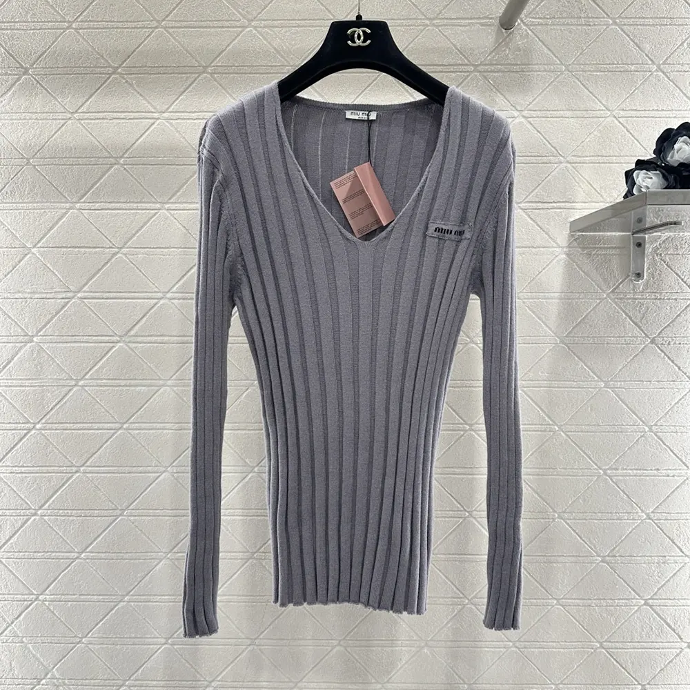 Close-up of soft knit and V-neck detail on Miu Miu sweater