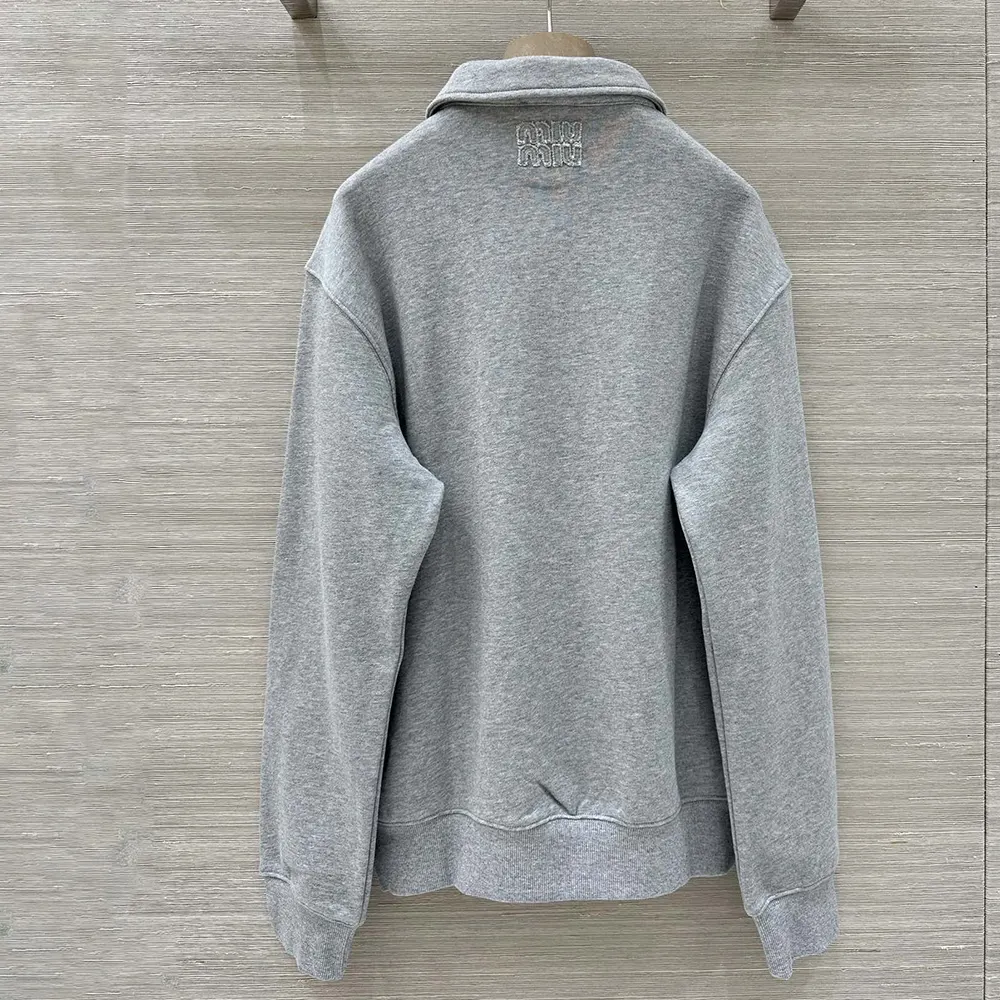Side profile showing relaxed fit of Miu Miu zippered cotton fleece jacket