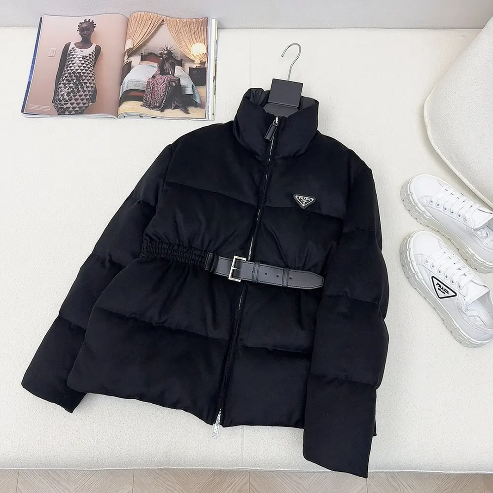 Close-up of Prada logo hardware on navy loden down jacket