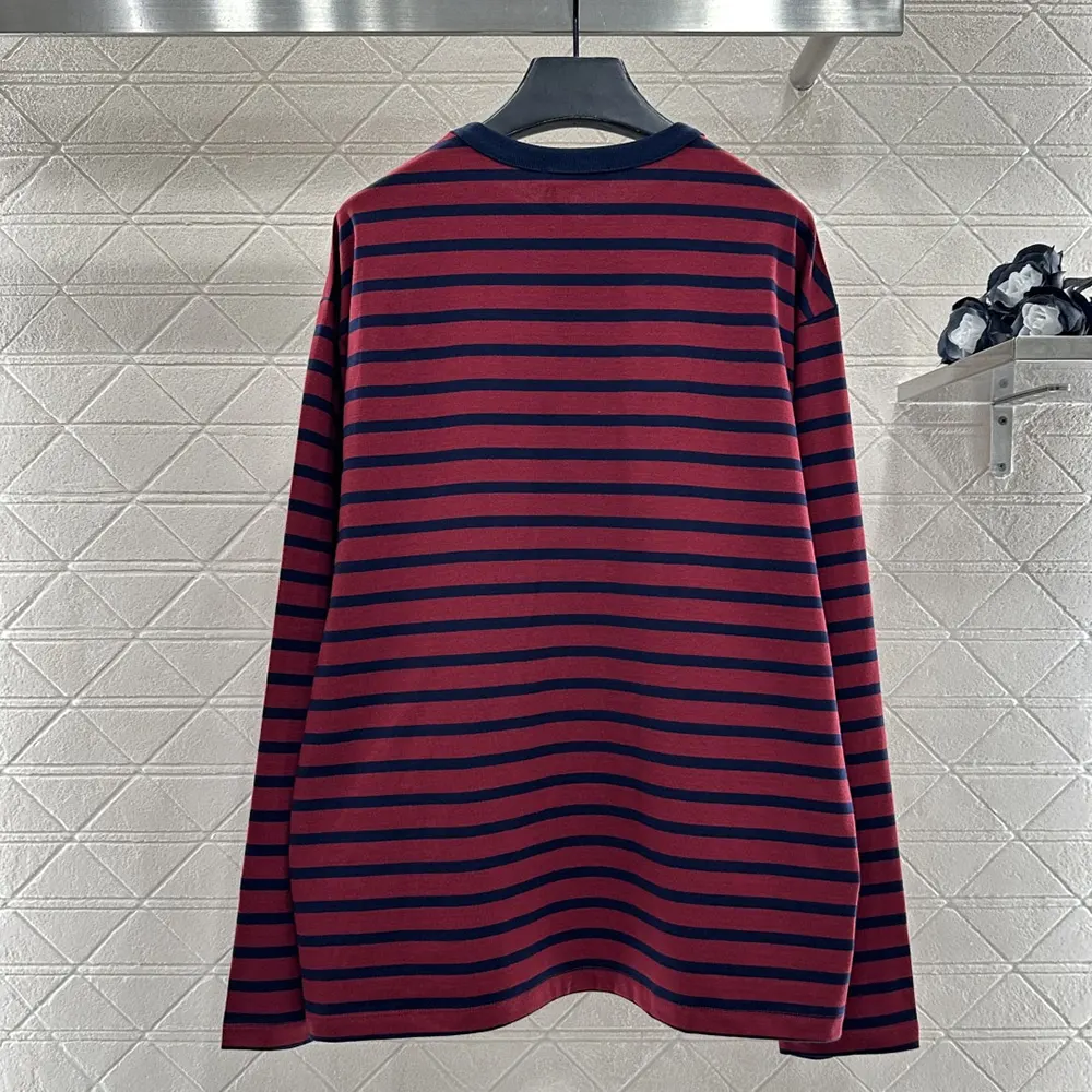 Detail of the subtle logo on Prada Women Long-Sleeved Striped Jersey T-Shirt hem