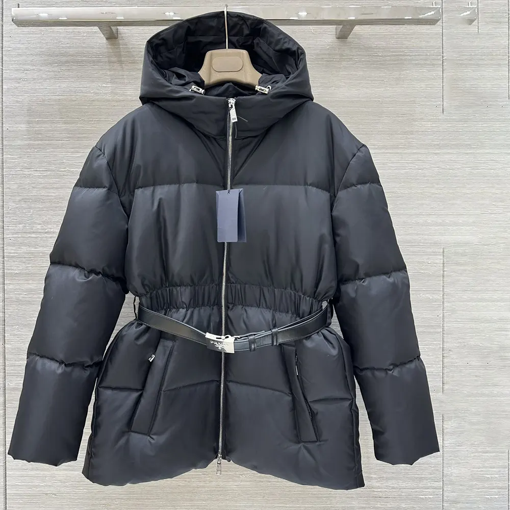 Close-up detail of Prada logo plaque on black Re-Nylon jacket