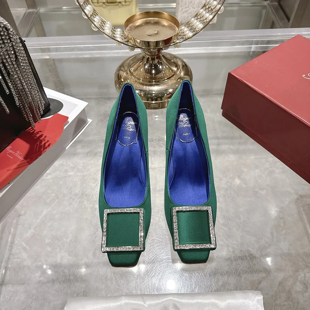 Close-up of polished silver buckle on Roger Vivier Trompette Pumps