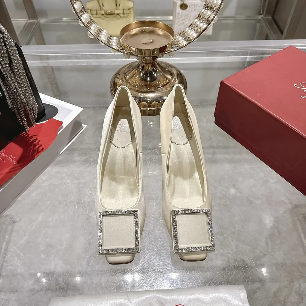 Close-up on crystal buckle detail of Roger Vivier Women Trompette Pumps