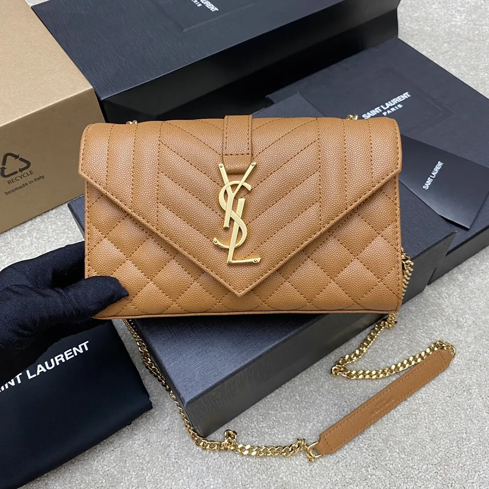 Close-up of gold YSL logo and quilted lambskin on Envelope Small bag