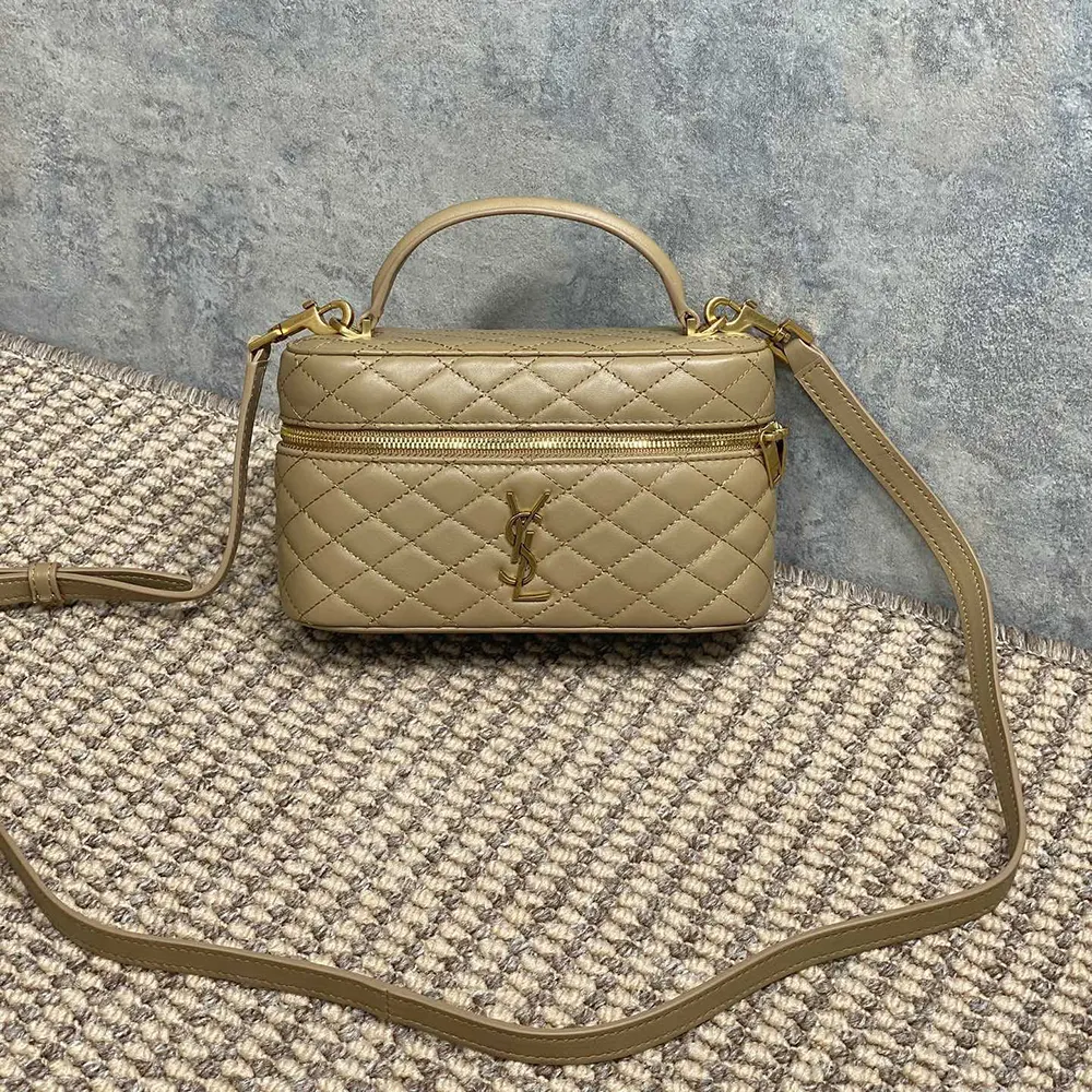 Close-up on gold YSL logo hardware on Gaby Vanity Bag in beige