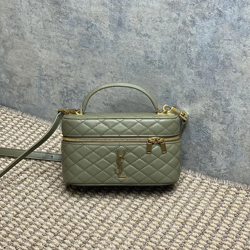 Close-up of gold-tone YSL logo hardware on green lambskin bag