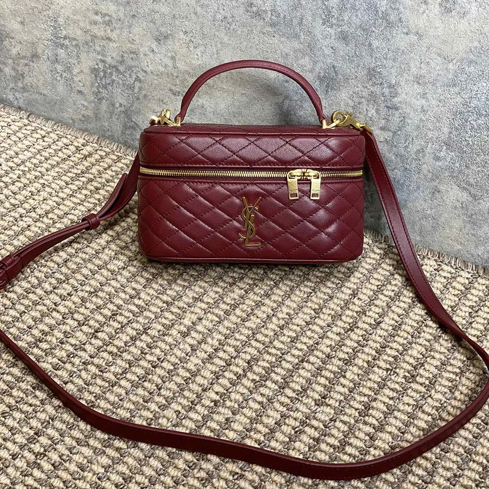 Close-up of YSL monogram gold hardware on Gaby Vanity Bag maroon leather