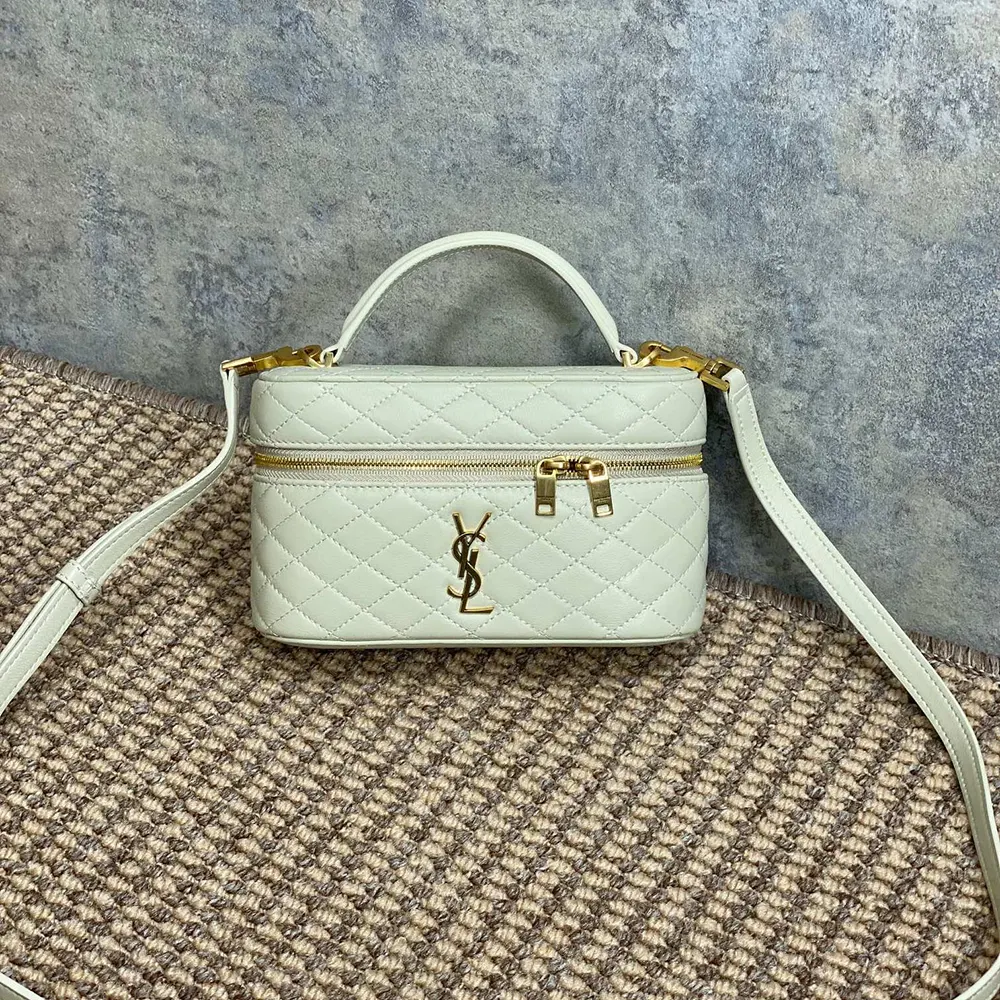 Close-up of gold YSL hardware on white lambskin Gaby Vanity Bag