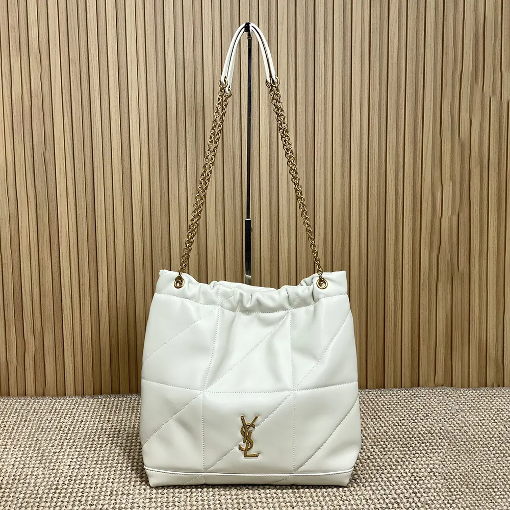 Close-up of gold YSL logo hardware on white lambskin bag