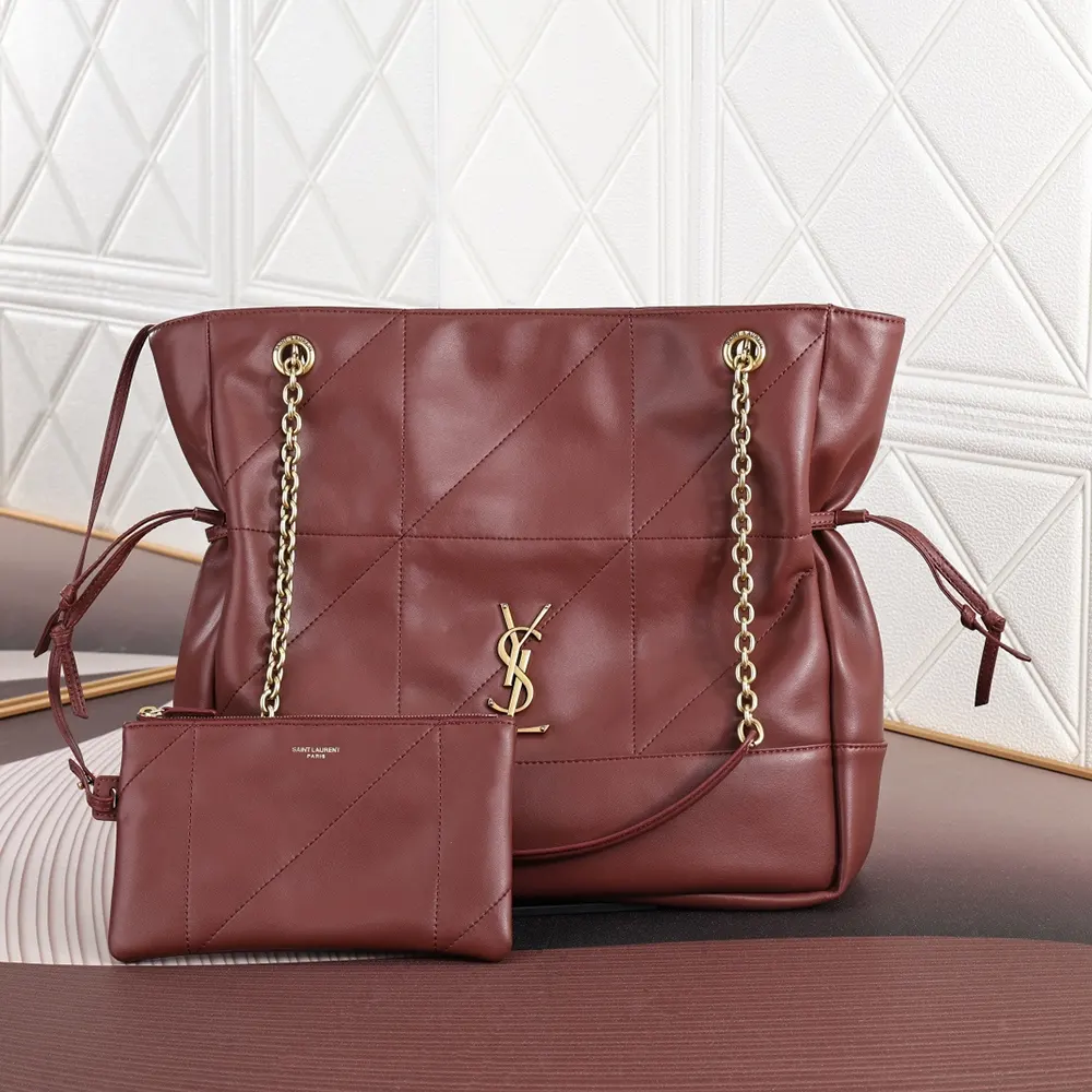 Close-up of gold YSL logo on maroon lambskin leather bag