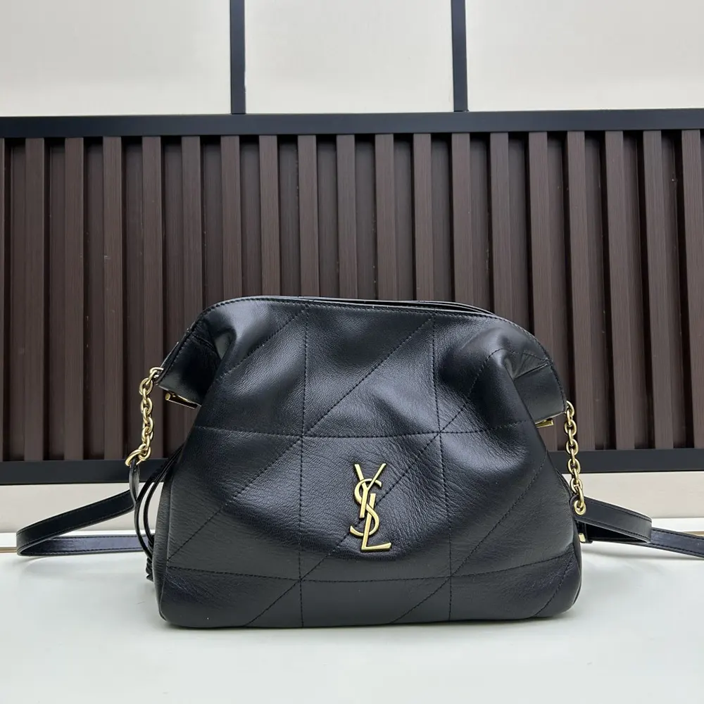 Close-up detail of YSL gold hardware on black lambskin pouch