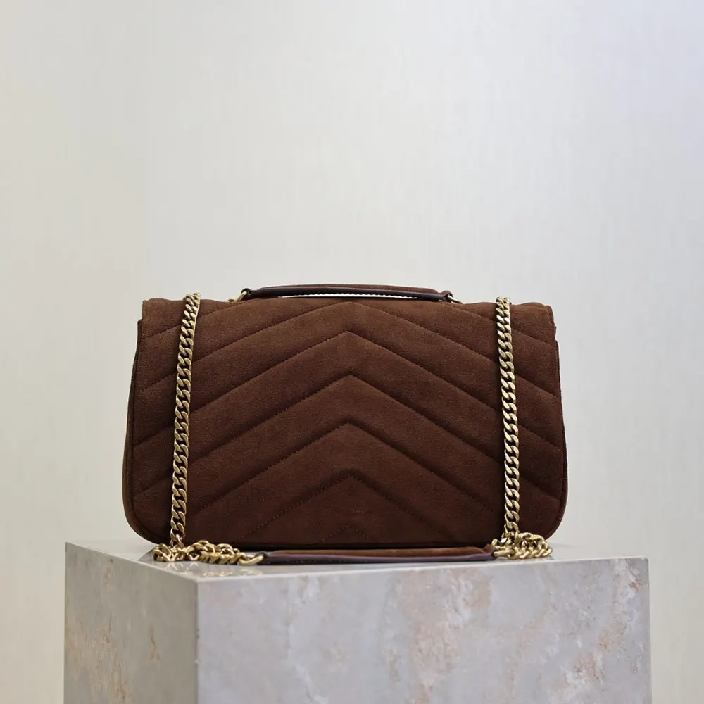 Side angle showing flap closure and brown matelassé suede texture