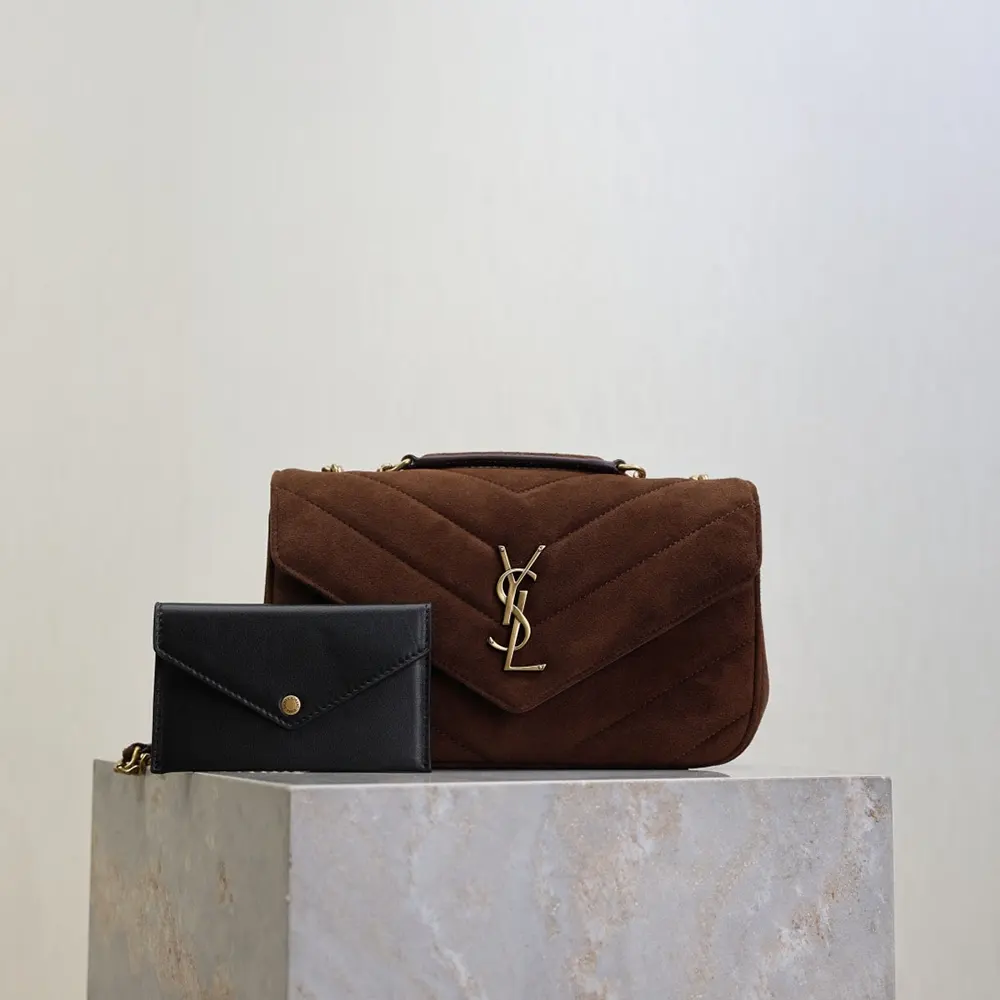 Close-up of gold YSL logo hardware on matelassé suede bag